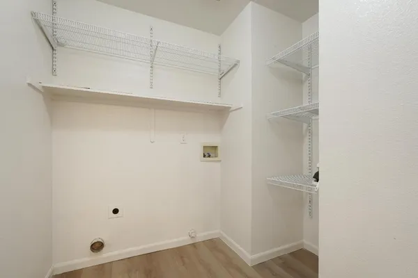 a view of walk in closet with empty racks