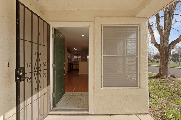 a view of a porch with wooden floor and a floor to ceiling window