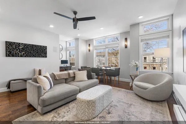 a living room with furniture a flat screen tv and kitchen view