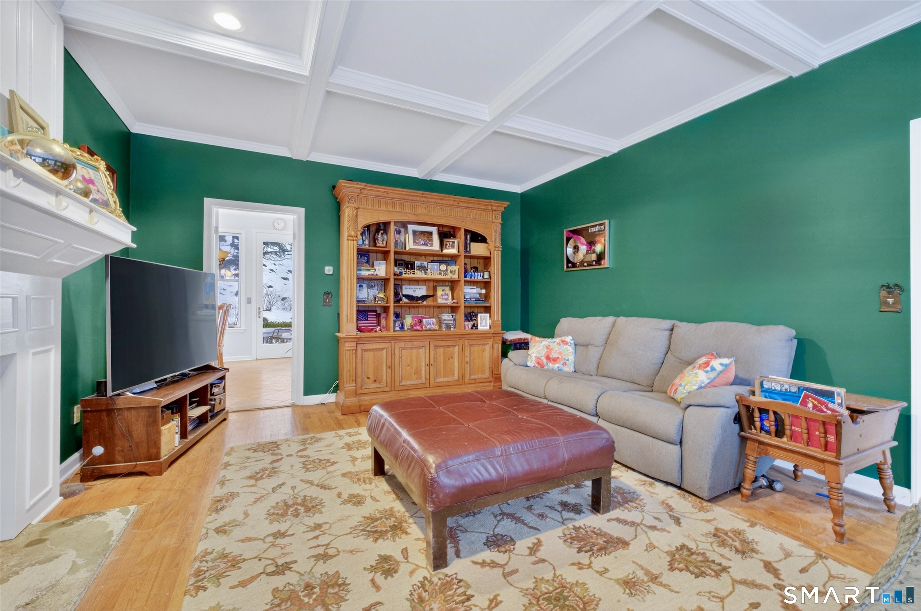 123 A Peaceable Street Redding, CT 06896 - Photo 25 of 44 a living room with furniture a flat screen tv and a bookshelf