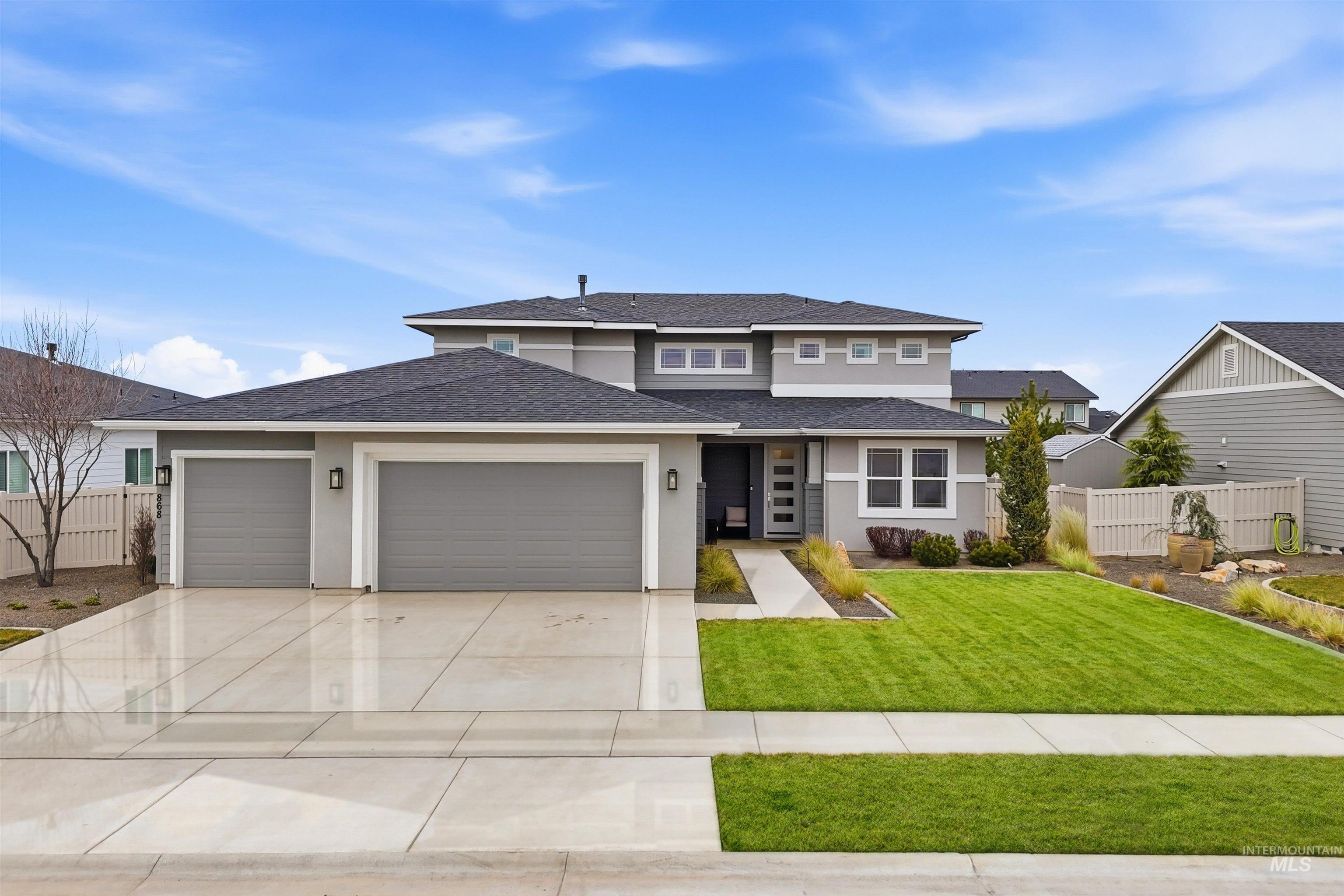 868 West Grassland Street Middleton, ID 83644 - Photo 1 of 39 Contemporary residence featuring a two-car garage, a separate single-car garage, and a concrete driveway