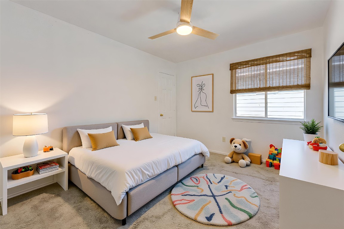 356 Wetzel Kyle, TX 78640 - Photo 13 of 24 a bedroom with a bed and a chandelier