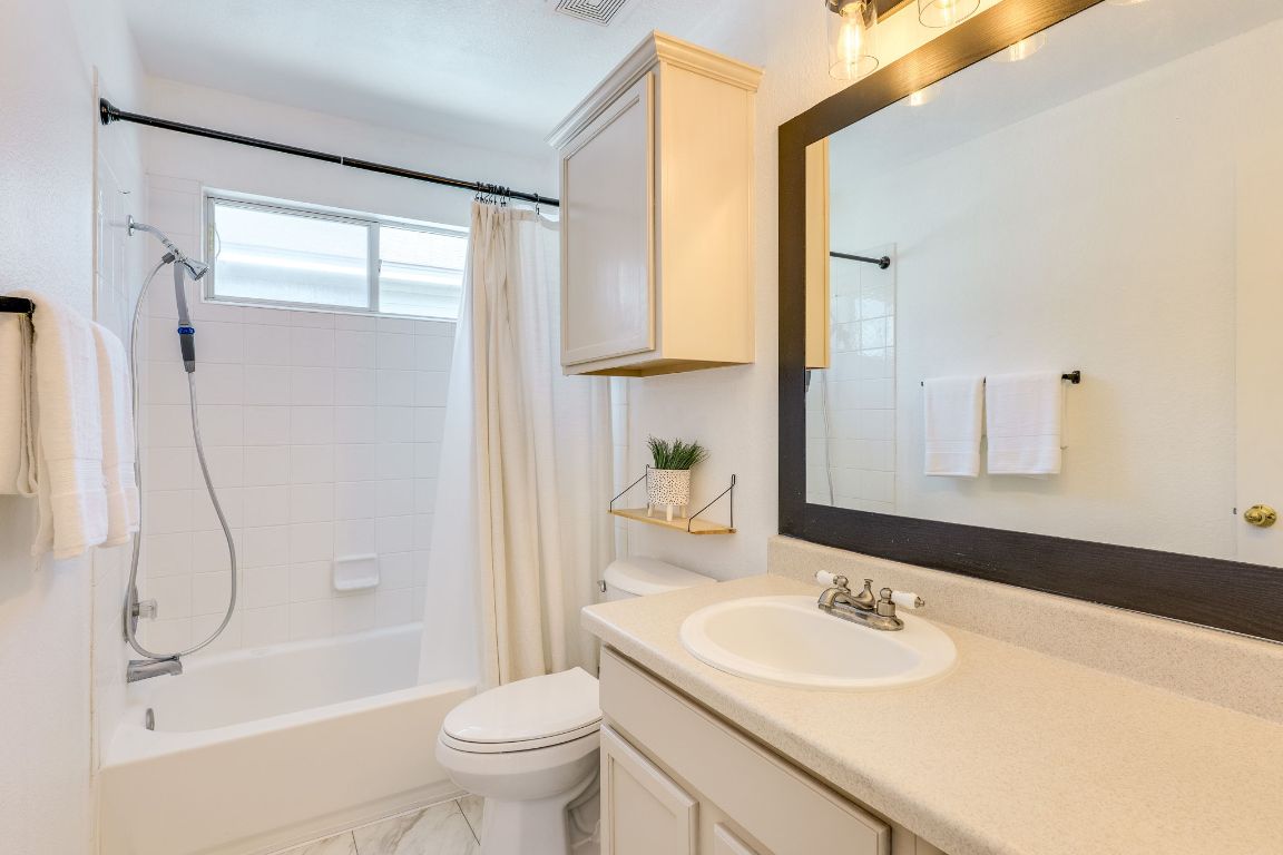 356 Wetzel Kyle, TX 78640 - Photo 15 of 24 a bathroom with a granite countertop sink toilet and shower