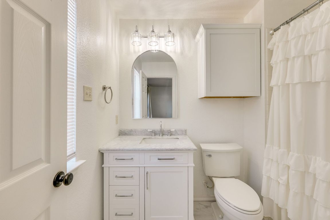 356 Wetzel Kyle, TX 78640 - Photo 17 of 24 a bathroom with a toilet sink and mirror