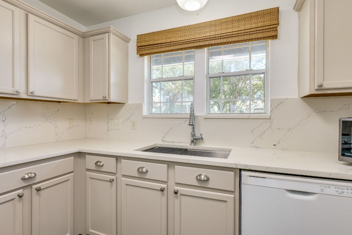 356 Wetzel Kyle, TX 78640 - Photo 5 of 24 a kitchen with a sink cabinets and window