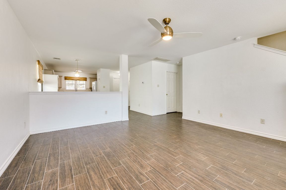 356 Wetzel Kyle, TX 78640 - Photo 8 of 24 an empty room with wooden floor and windows