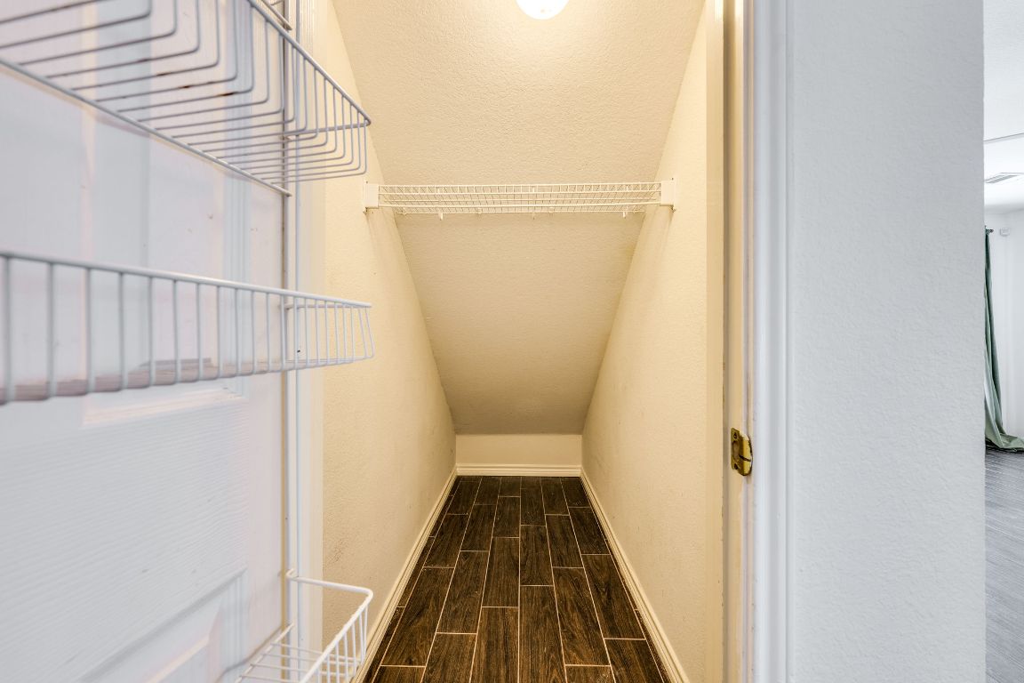 356 Wetzel Kyle, TX 78640 - Photo 10 of 24 a view of a hallway with wooden floor and staircase