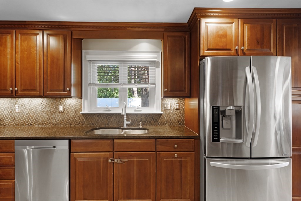 32 Concord Road Chelmsford, MA 01824 - Photo 11 of 27 a kitchen with stainless steel appliances granite countertop a refrigerator and a sink
