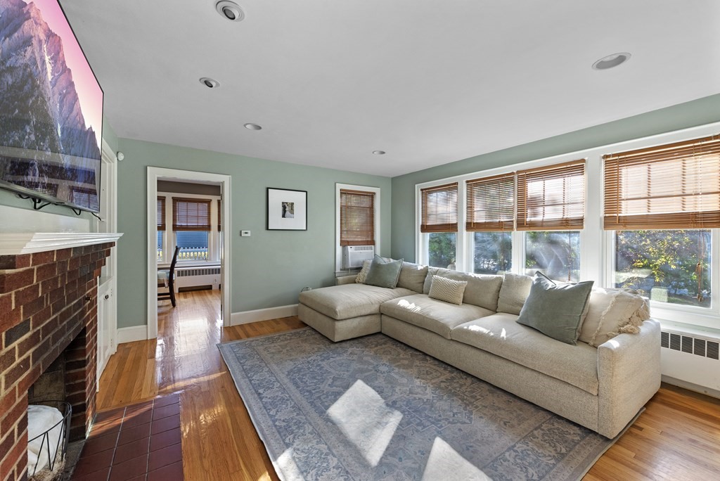 32 Concord Road Chelmsford, MA 01824 - Photo 20 of 27 a living room with fireplace furniture and a wooden floor