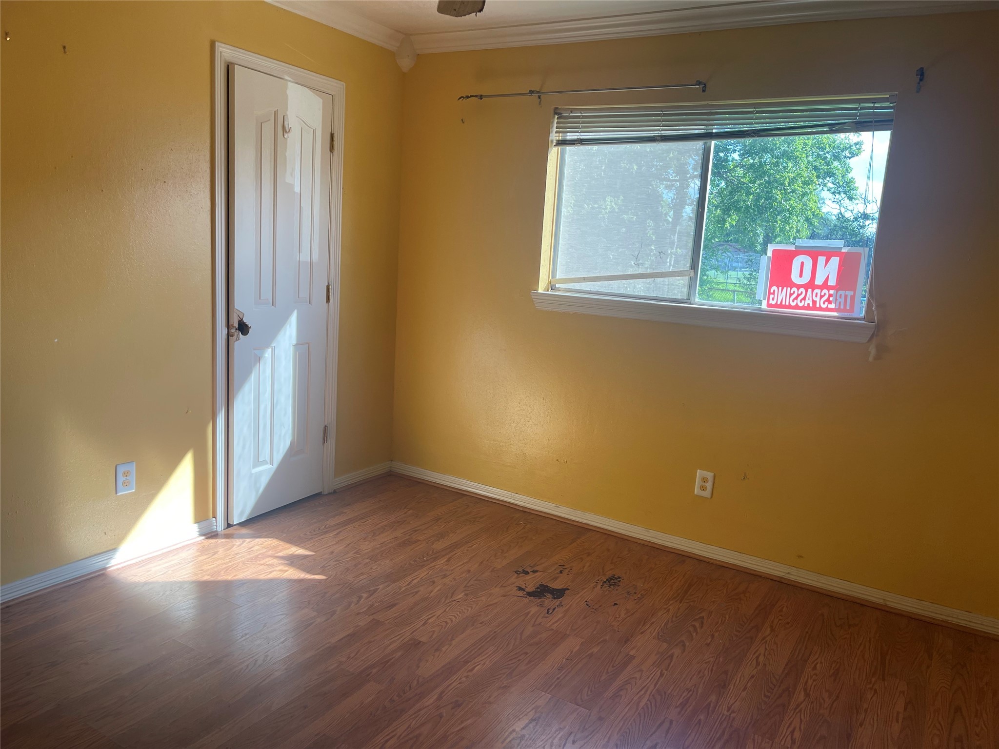 8703 Ashwyne Lane La Porte, TX 77571 - Photo 4 of 7 an empty room with wooden floor and windows