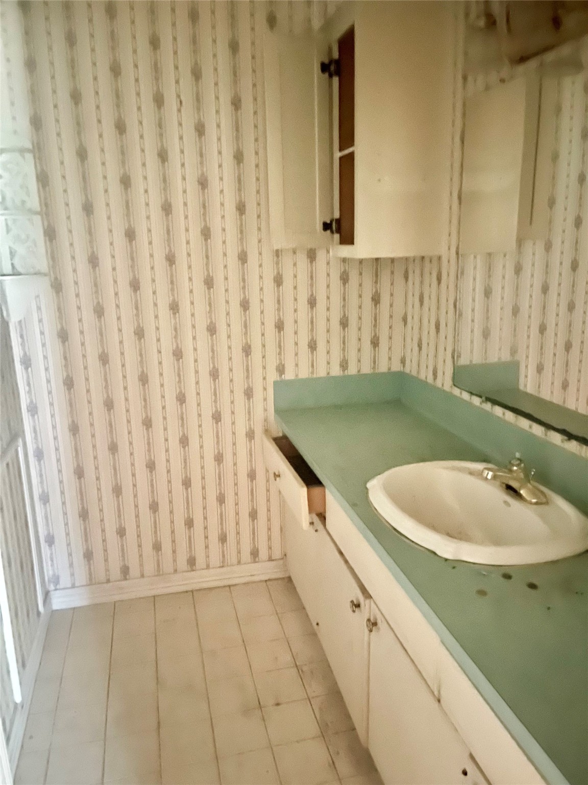 8703 Ashwyne Lane La Porte, TX 77571 - Photo 5 of 7 a bathroom with a sink a toilet and a shower curtain