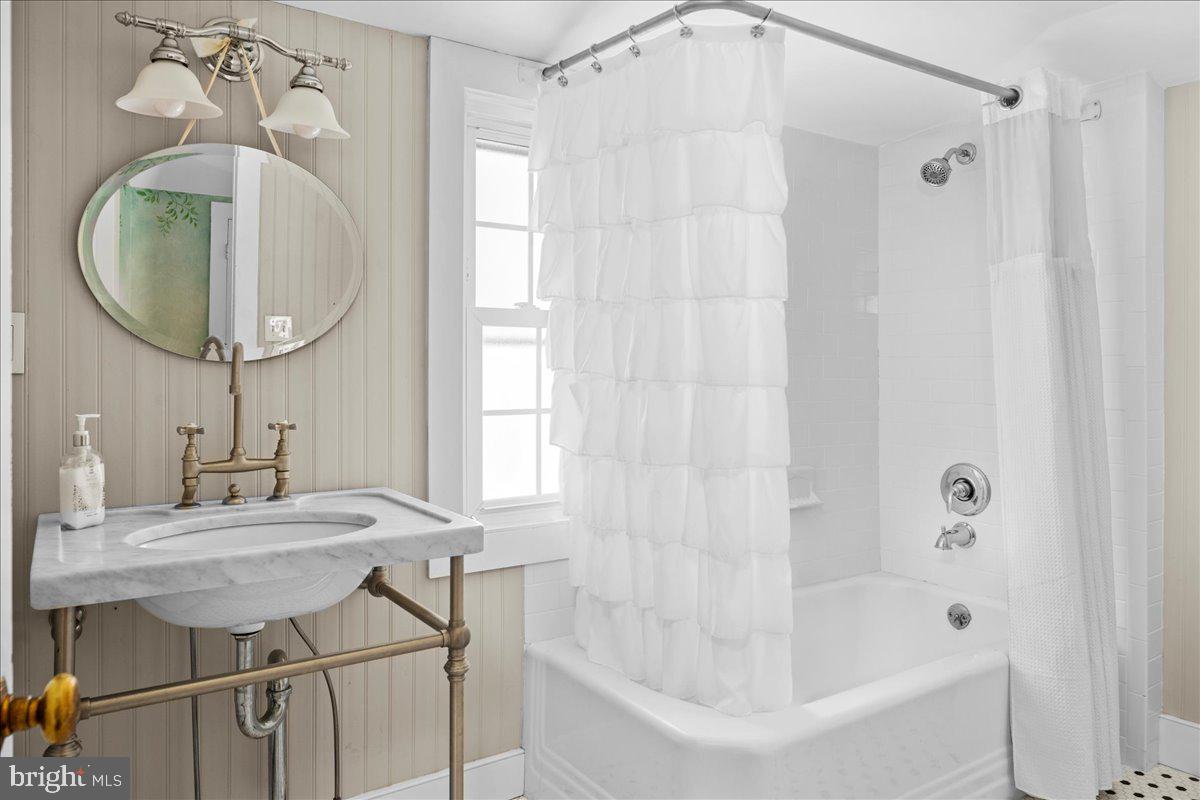 1515 Sugar Bottom Road Furlong, PA 18925 - Photo 37 of 52 a bathroom with a sink a mirror and a bathtub