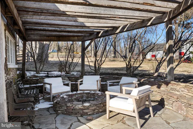 a building outdoor space with patio furniture and potted plants
