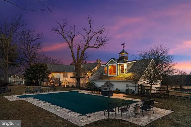 a front view of a house with garden and sitting area