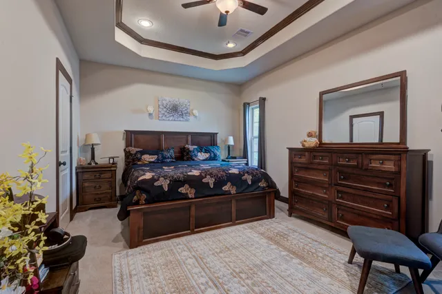 a bedroom with a bed and a chandelier