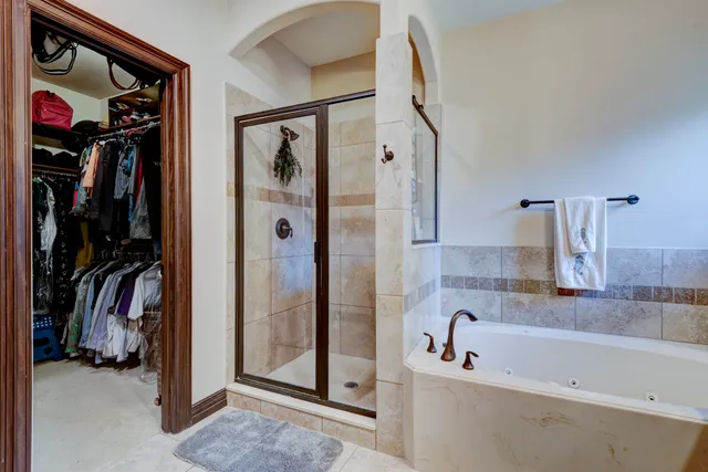a bathroom with a bathtub and a shower