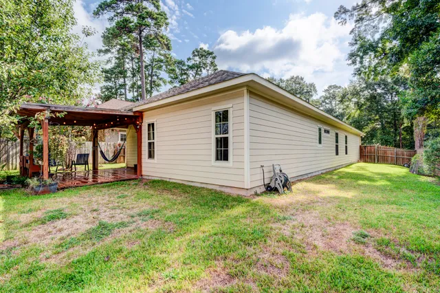 a view of a chair and table in backyard of the house