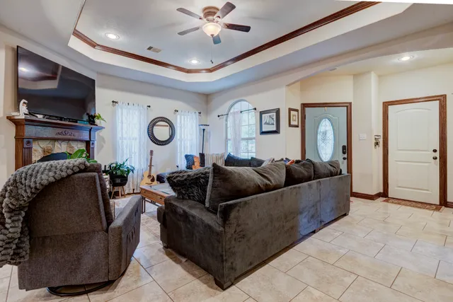 a living room with furniture and a flat screen tv