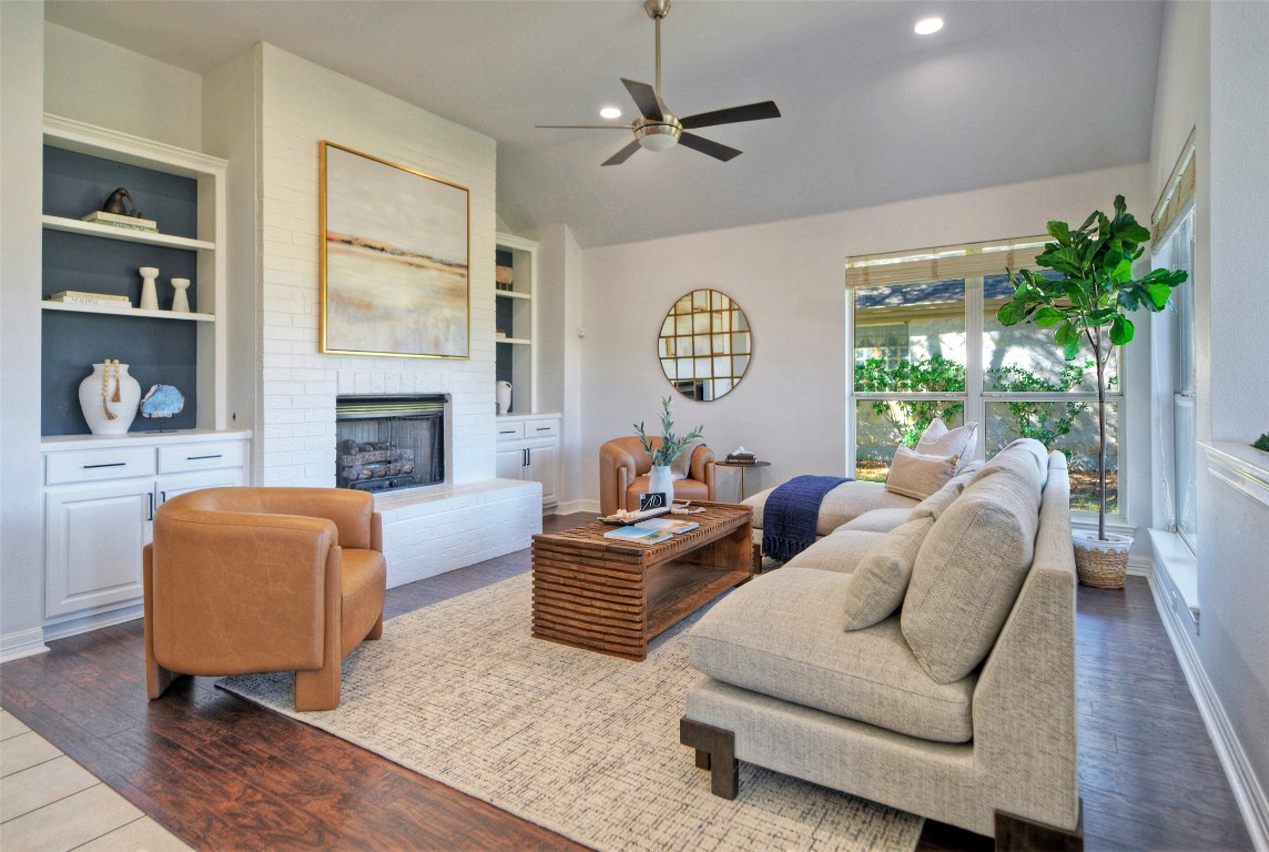 10833 Olympia Fields Loop Austin, TX 78747 - Photo 12 of 38 a living room with furniture fireplace and a window