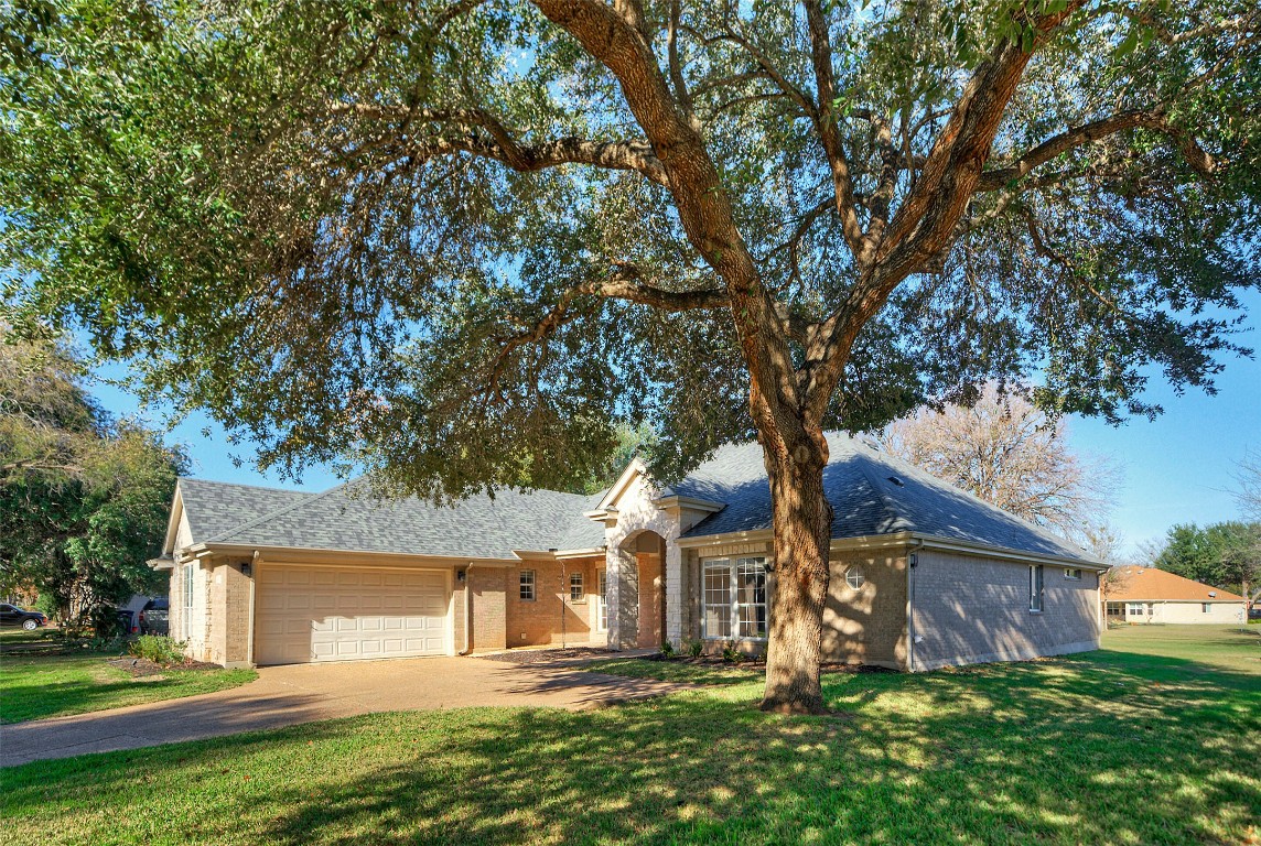 10833 Olympia Fields Loop Austin, TX 78747 - Photo 2 of 38 front view of a house with a tree