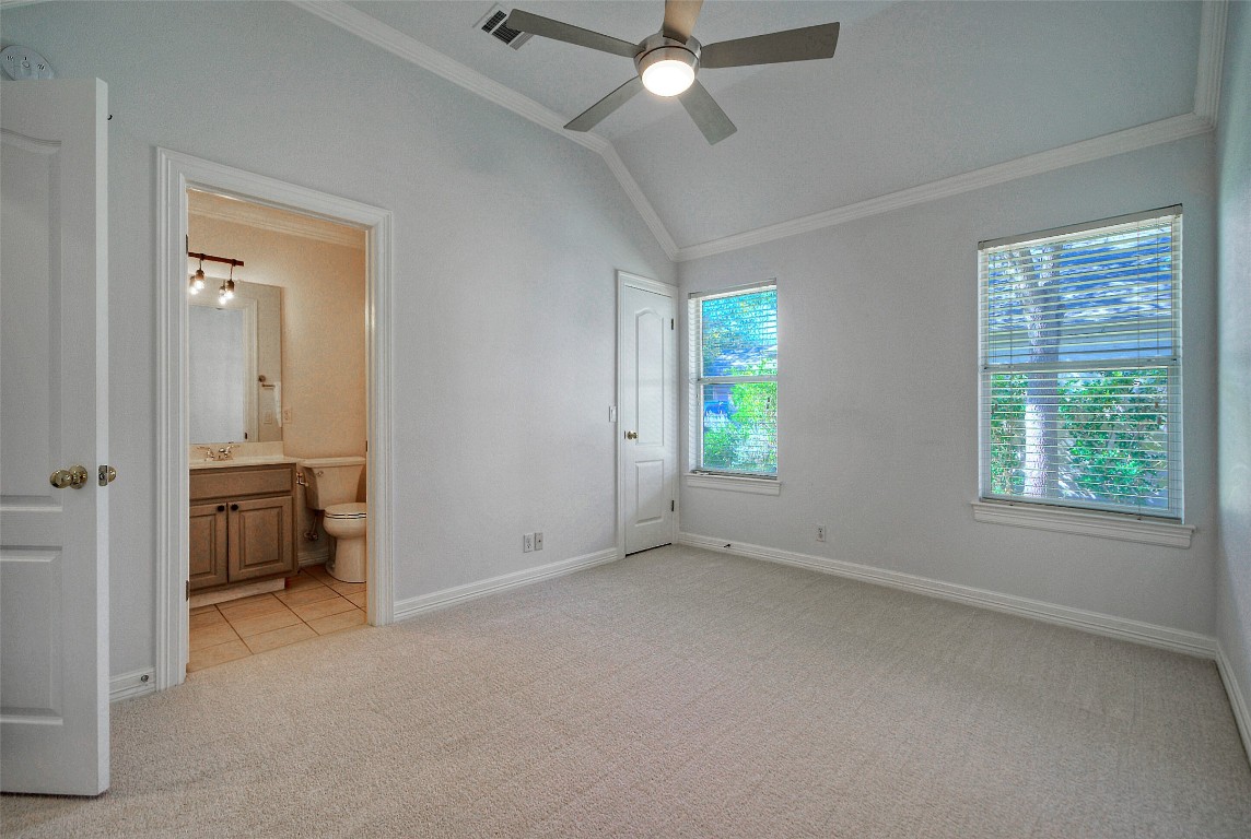 10833 Olympia Fields Loop Austin, TX 78747 - Photo 23 of 38 an empty room with windows and fan