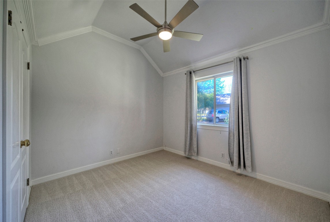 10833 Olympia Fields Loop Austin, TX 78747 - Photo 25 of 38 an empty room that has a window and a fan