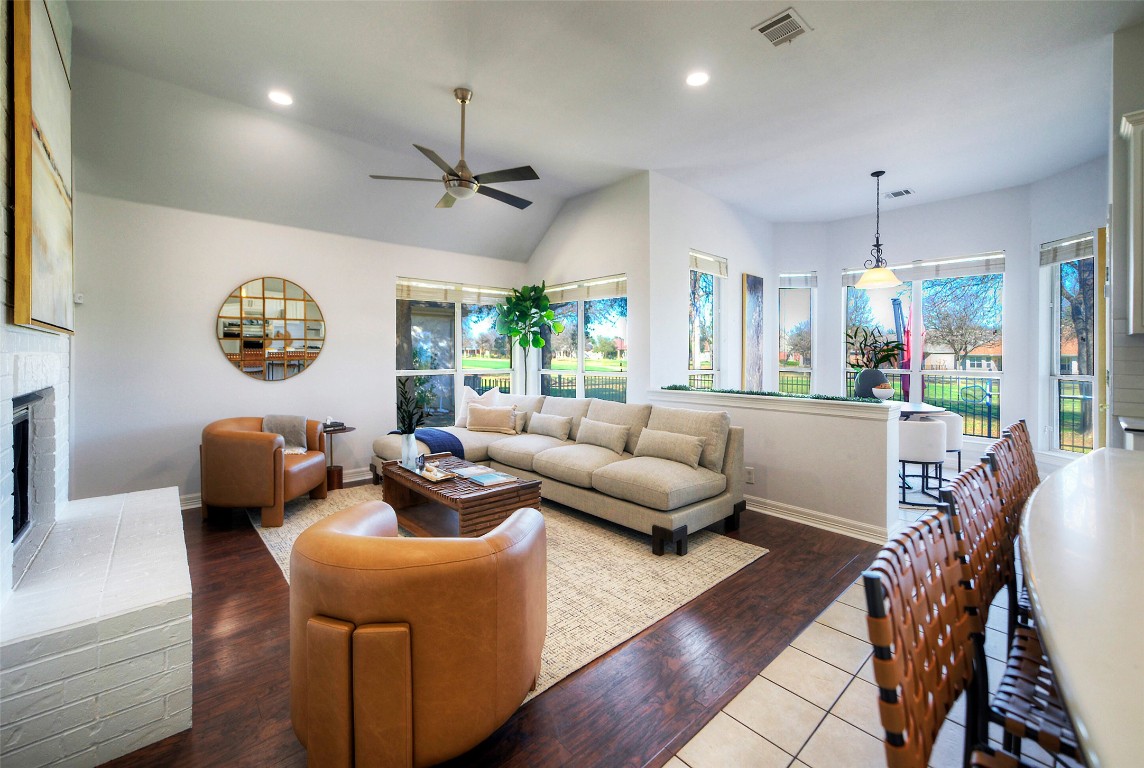 10833 Olympia Fields Loop Austin, TX 78747 - Photo 10 of 38 a living room with furniture a chandelier and a large window