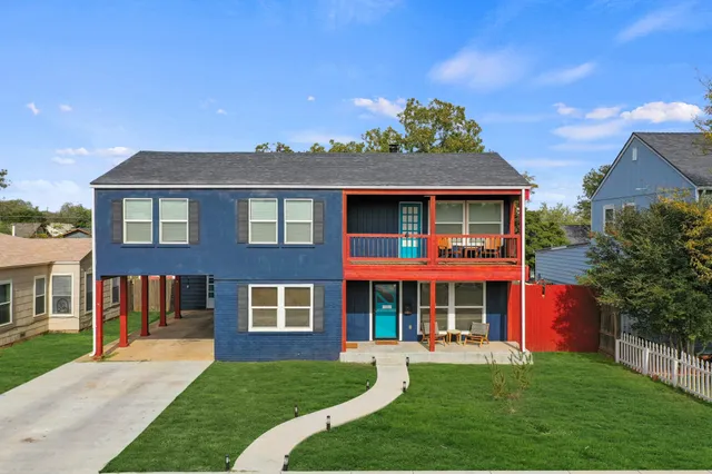 front view of a brick house with a yard
