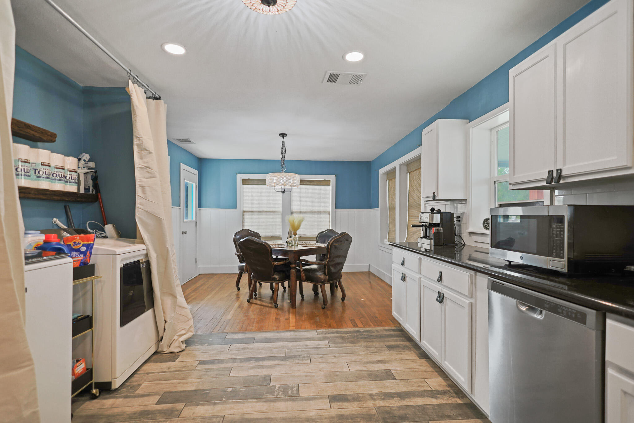 1904 28th Street Lubbock, TX 79411 - Photo 26 of 59 a kitchen with stainless steel appliances granite countertop a stove top oven a sink dishwasher and white cabinets with wooden floor