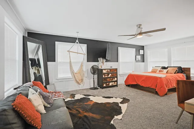 a view of a balcony with chairs and wooden floor