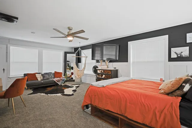 a bedroom with a large bed and a dresser