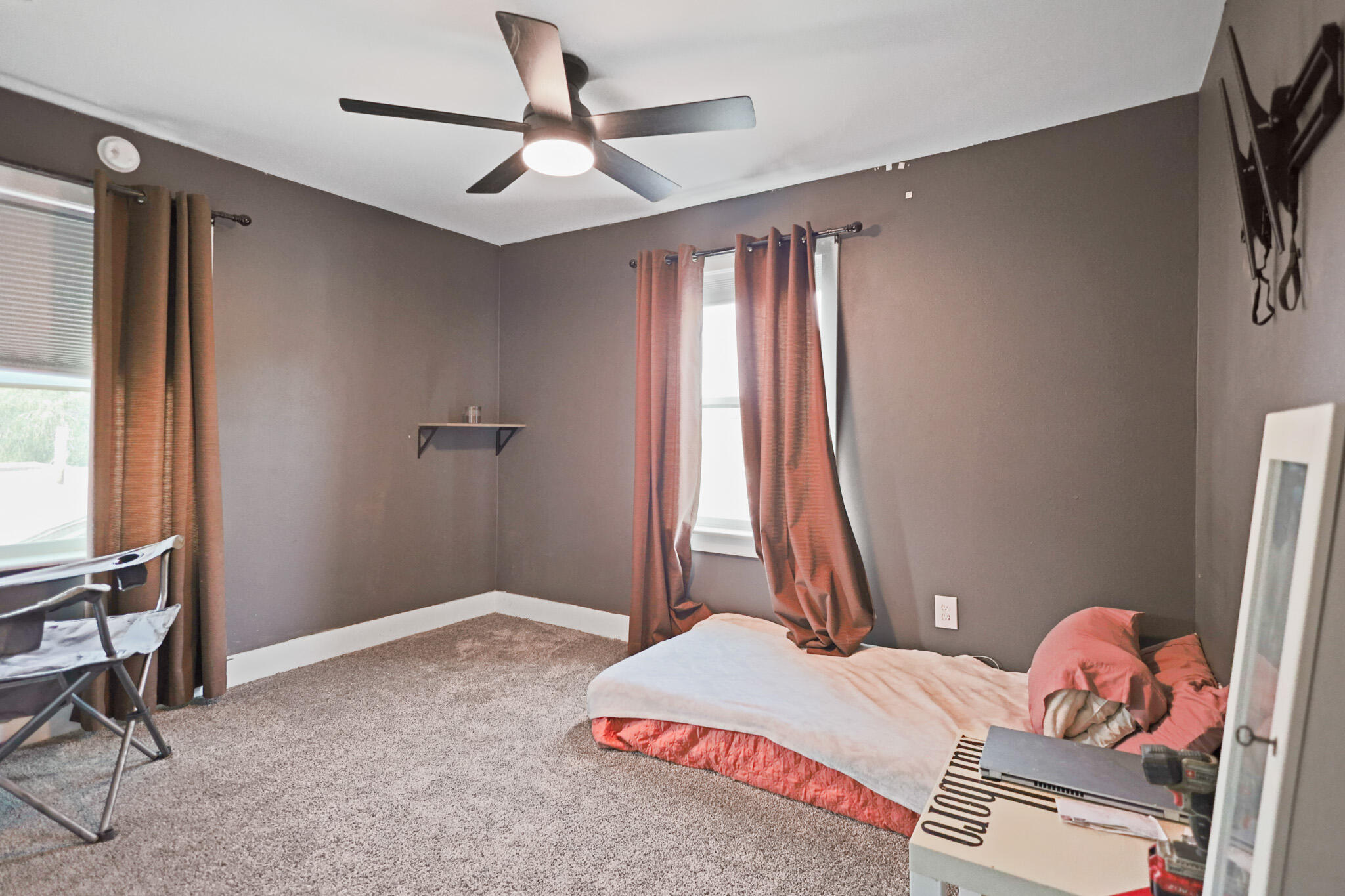 1904 28th Street Lubbock, TX 79411 - Photo 42 of 59 a bedroom with a bed and a chandelier