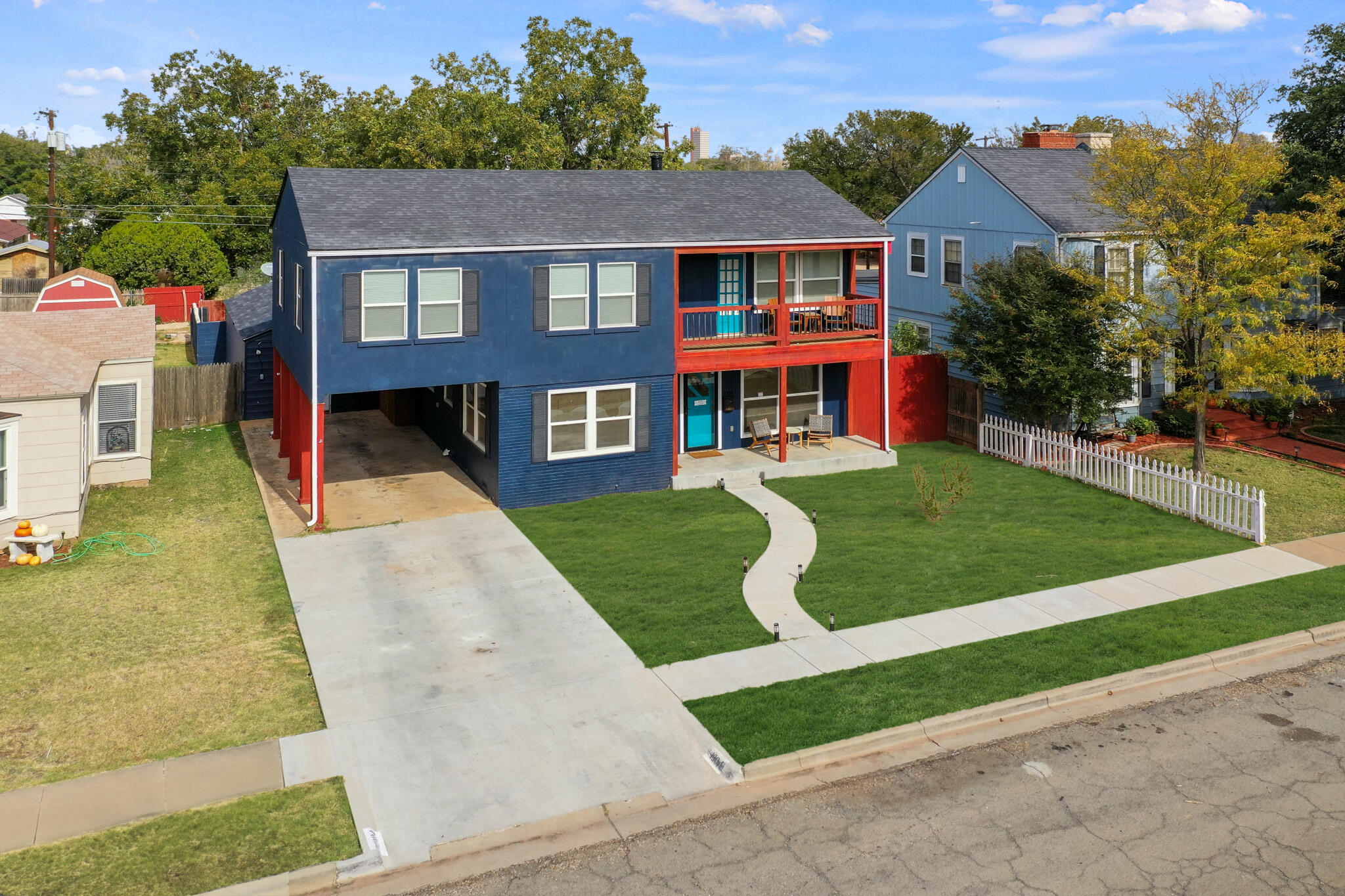 1904 28th Street Lubbock, TX 79411 - Photo 5 of 59 a front view of a house with a yard and garage