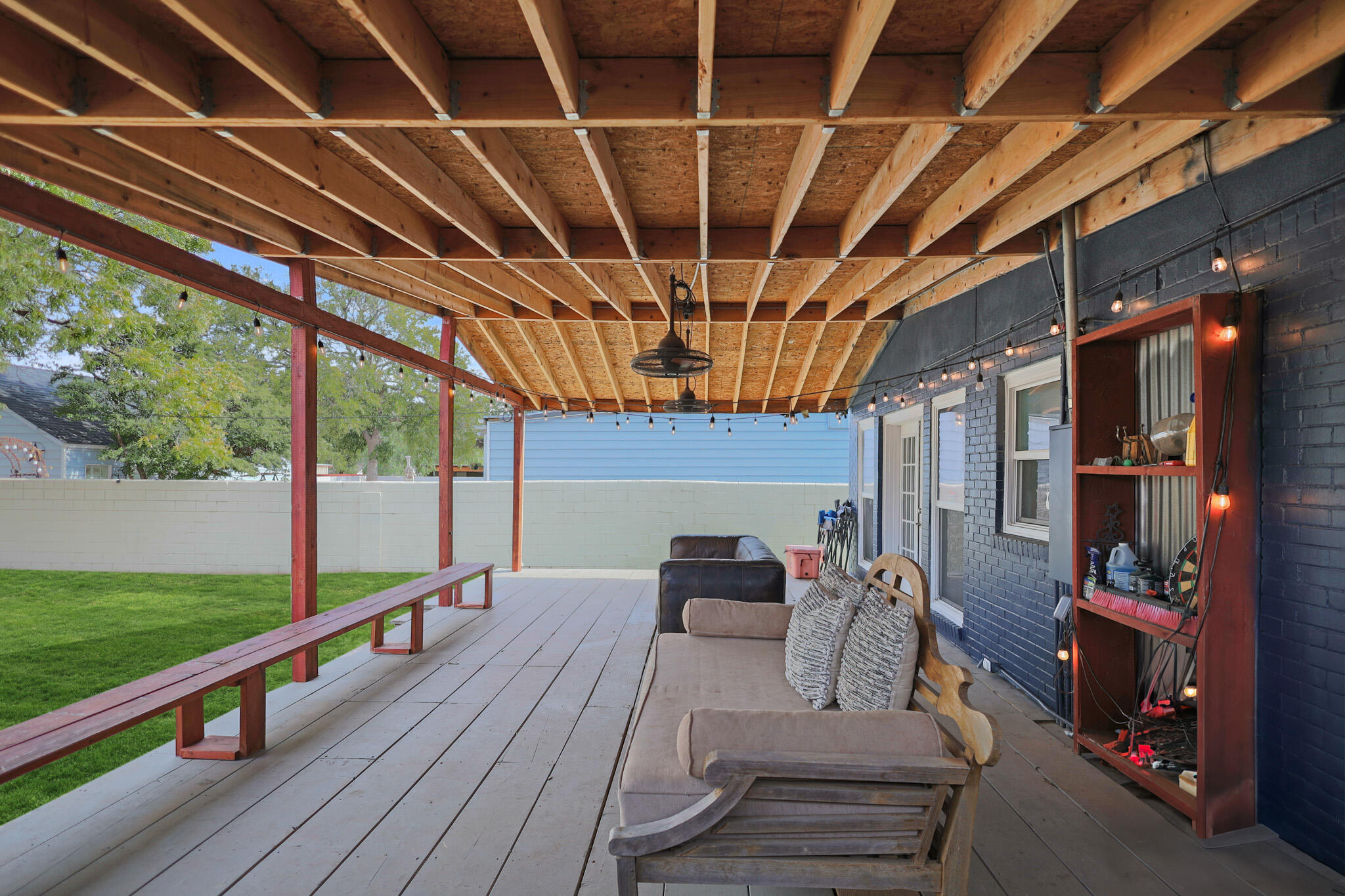 1904 28th Street Lubbock, TX 79411 - Photo 51 of 59 a view of a patio with table and chairs potted plants with wooden floor and fence
