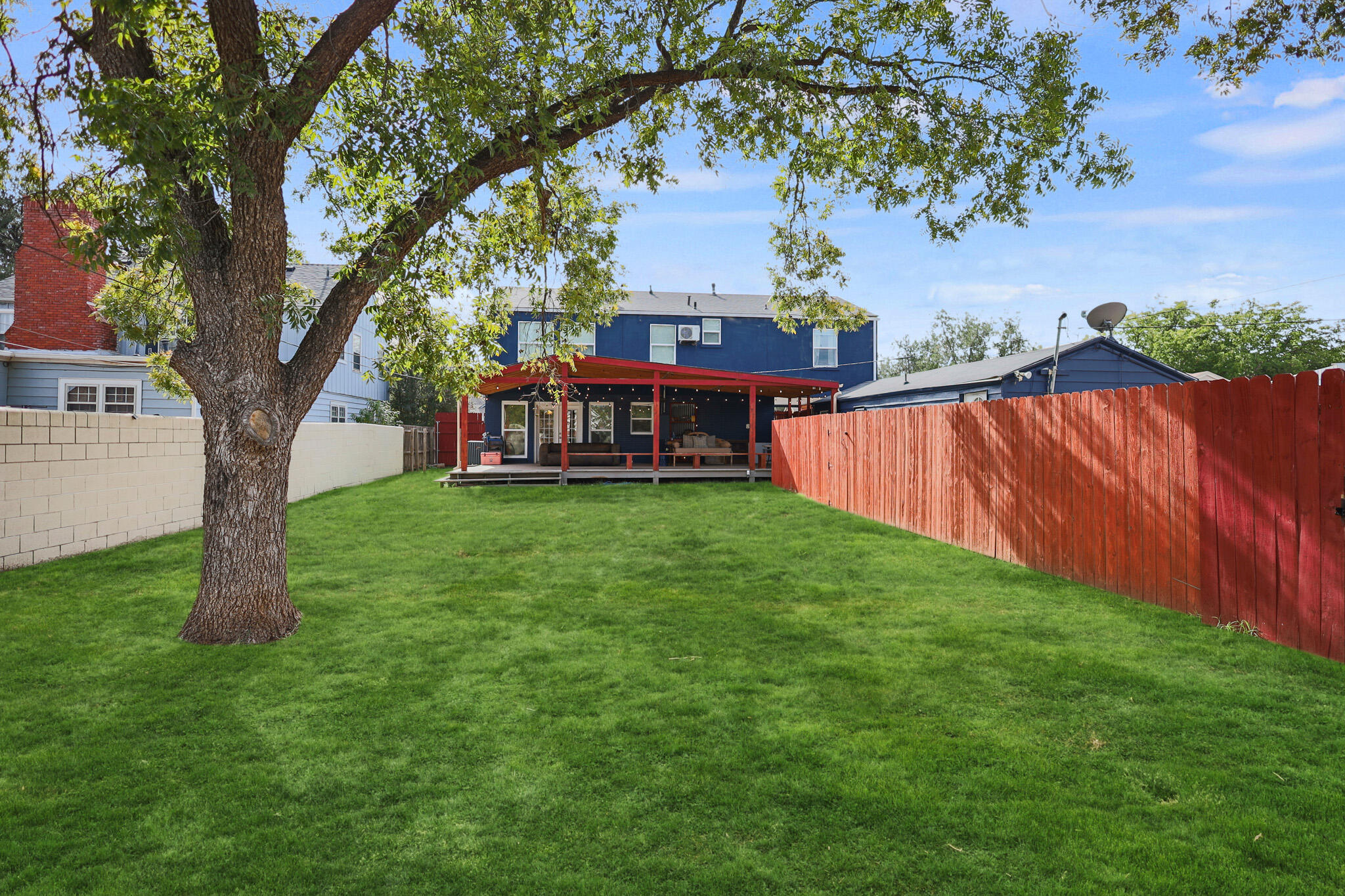 1904 28th Street Lubbock, TX 79411 - Photo 56 of 59 a view of a yard with a house and a large tree