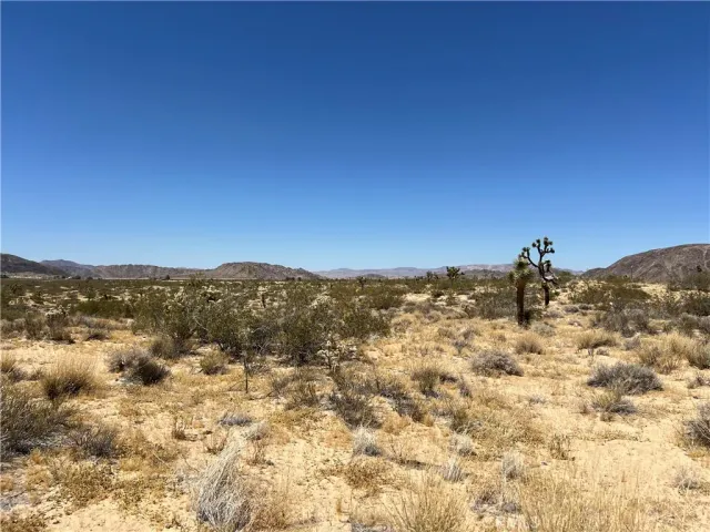 a view of a large building with mountains in the background