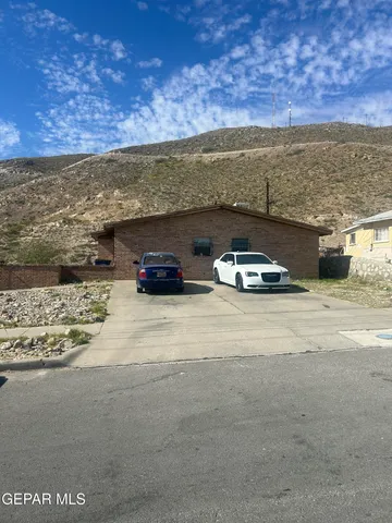 a view of car parked on road with ocean view