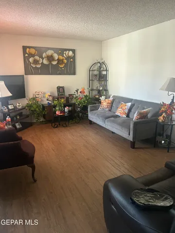 a living room with furniture and flowers
