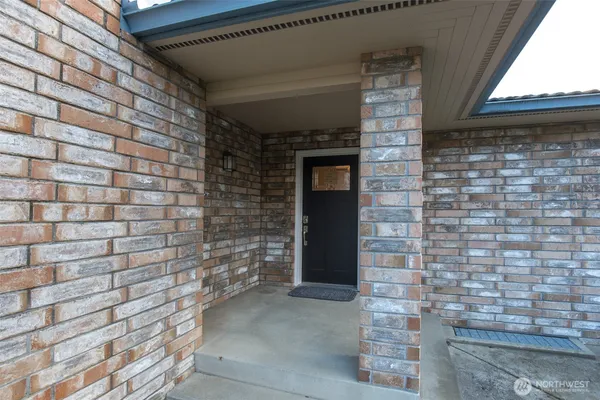 a brick building with a door and a shower
