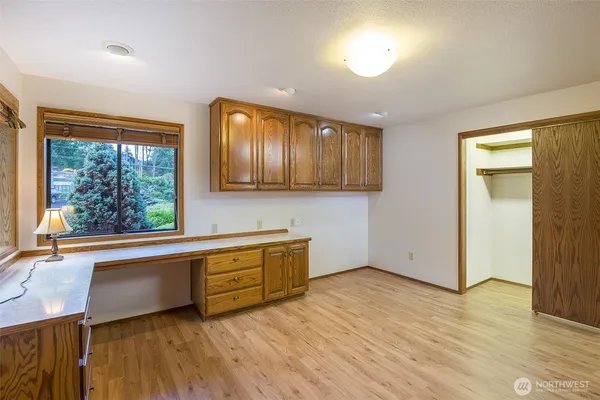 a kitchen with stainless steel appliances granite countertop wooden cabinets a stove a sink and a window