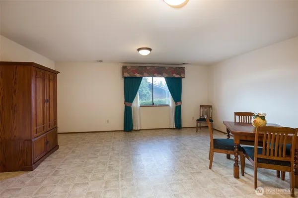 an empty room with furniture and a window