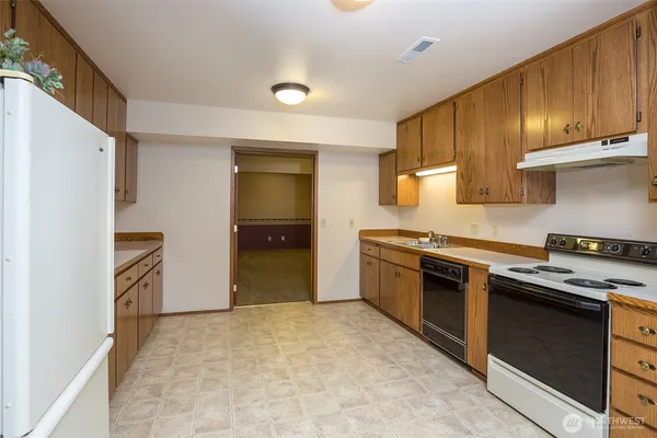 a kitchen with stainless steel appliances granite countertop a stove and a refrigerator