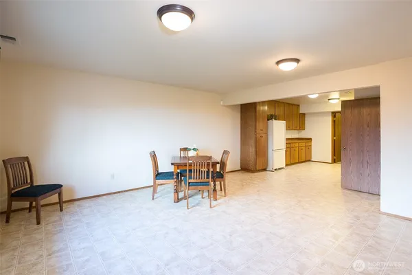 a view of a livingroom with furniture and a kitchen
