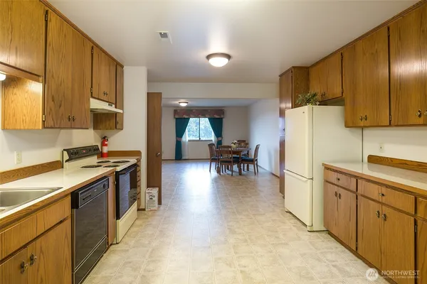 a kitchen with stainless steel appliances granite countertop a stove refrigerator sink and cabinets