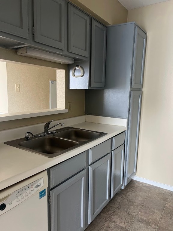 2811 Rio Grande Street, Unit 303 Austin, TX 78705 - Photo 5 of 11 a kitchen with a sink and a refrigerator