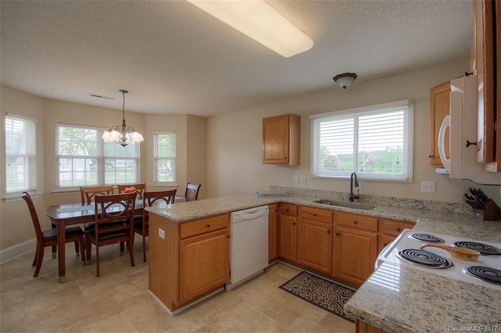 6114 Olive Branch Road Wingate, NC 28174 - Photo 14 of 24 a kitchen that has a sink and chair in it