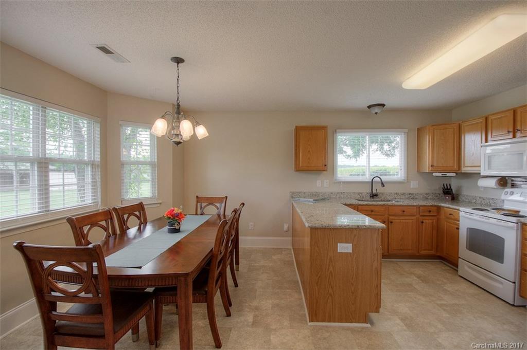 6114 Olive Branch Road Wingate, NC 28174 - Photo 18 of 24 a view of a dining room with furniture window and wooden floor