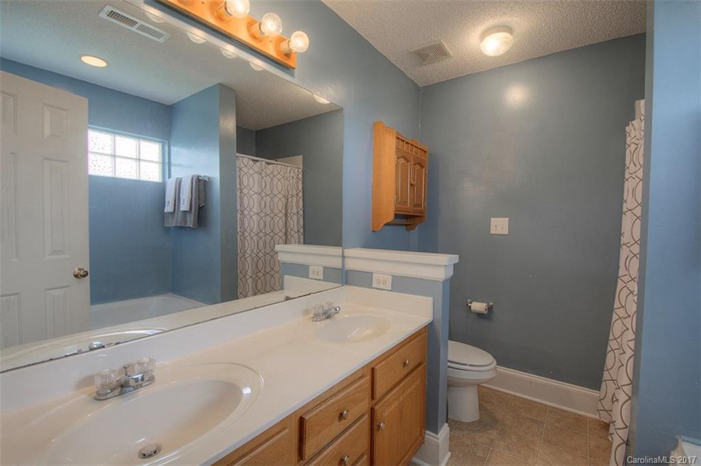 6114 Olive Branch Road Wingate, NC 28174 - Photo 20 of 24 a bathroom with a sink a toilet and shower