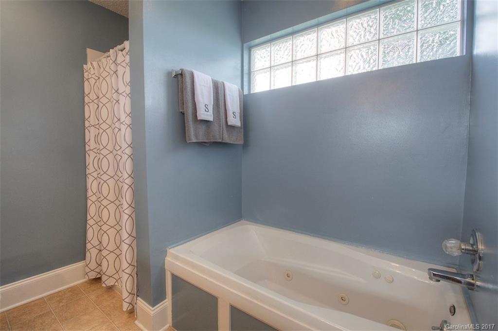 6114 Olive Branch Road Wingate, NC 28174 - Photo 21 of 24 a bathroom with a bathtub and shower