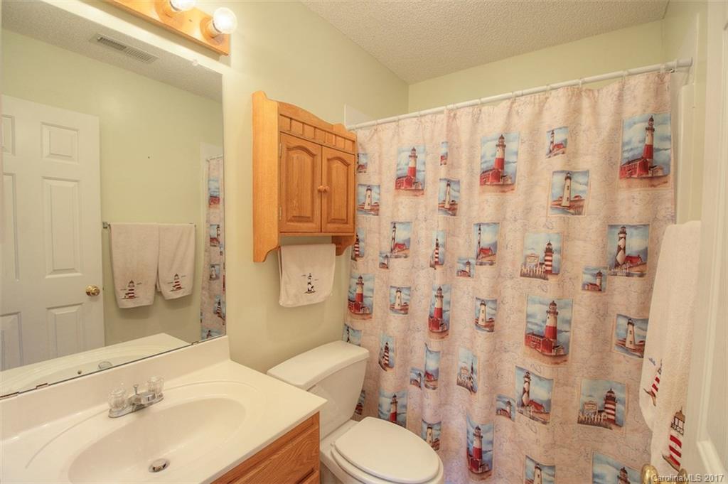 6114 Olive Branch Road Wingate, NC 28174 - Photo 23 of 24 a bathroom with a sink toilet and shower